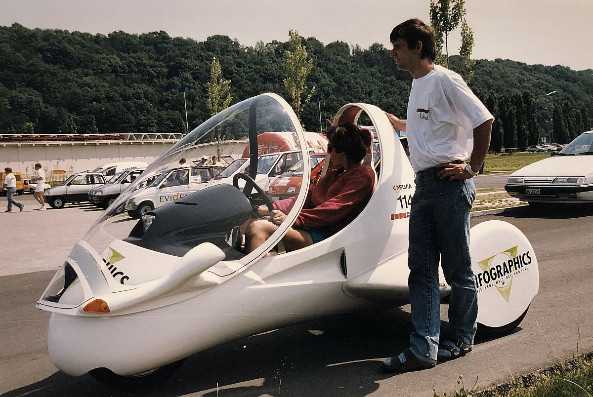 Tina Kyburz sitting in the Cheetah, Martin Kyburz standing next to her.