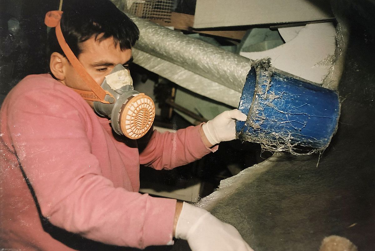 Martin Kyburz wears a protective mask with a bucket full of epoxy resin.